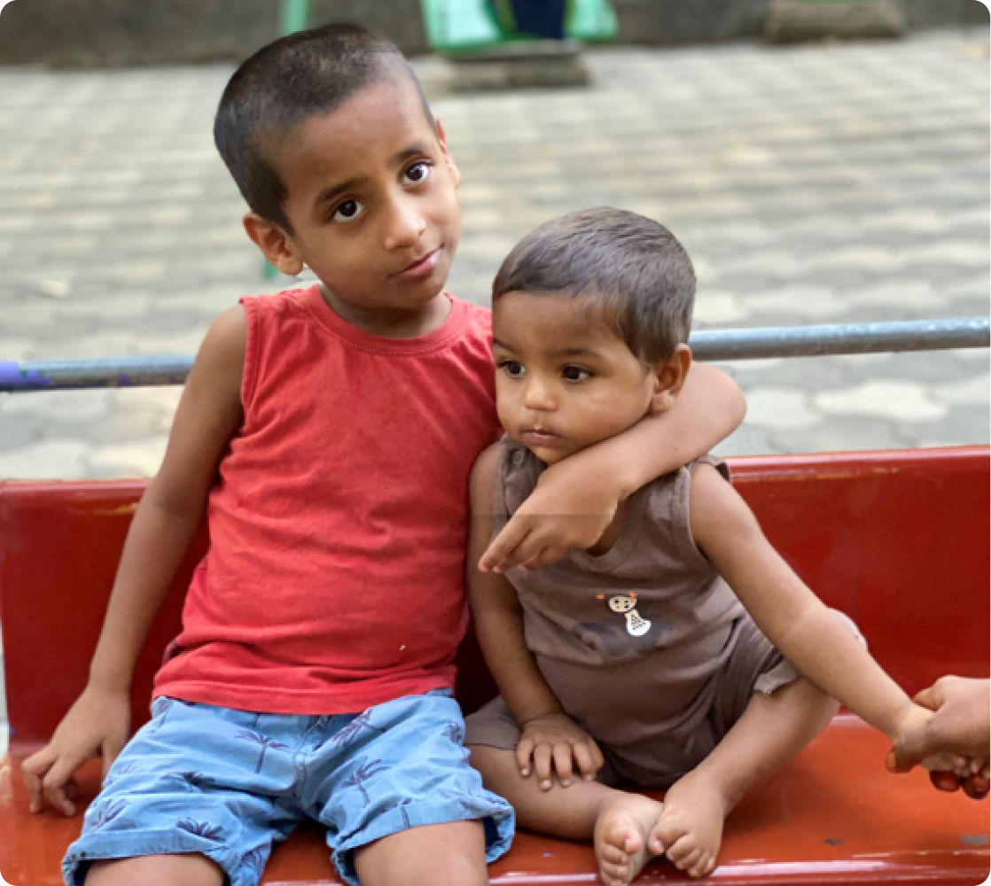 Two young boys supported by El Shaddai