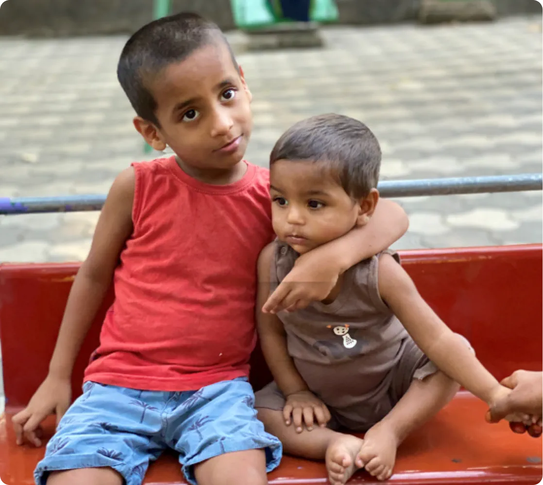 Two young boys supported by El Shaddai